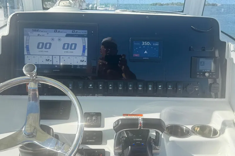 Slide: The Image of Dashboard of a 2019 Sea Hunt Ultra 275 SE boat with navigation and control systems. - 18