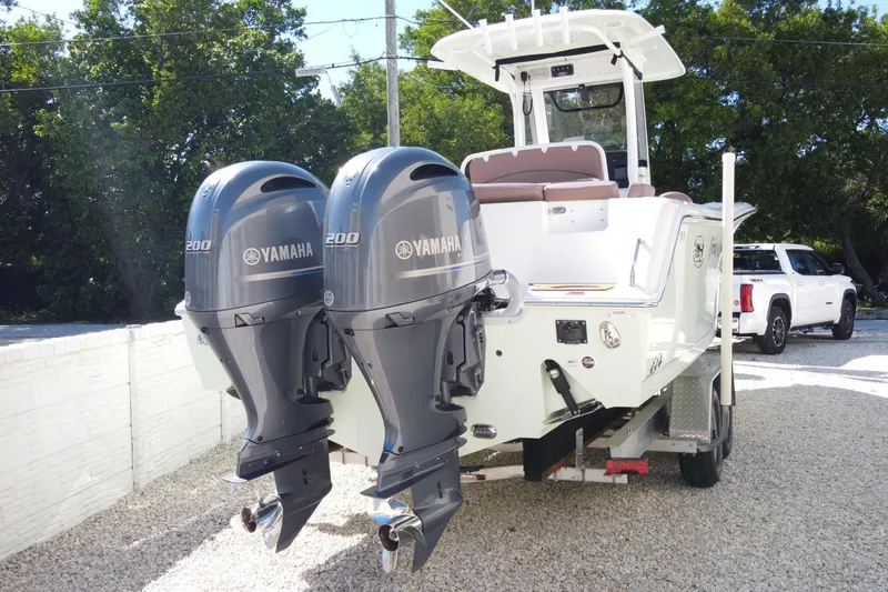 Slide: The Image of 2019 Sea Hunt Ultra 275 SE boat with dual Yamaha 200 engines on a trailer. - 2
