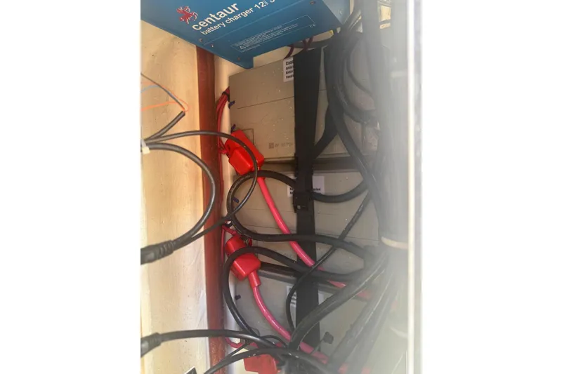 Slide: The Image of Electrical wiring and battery charger inside a 2019 Sea Hunt Ultra 275 SE boat. - 23