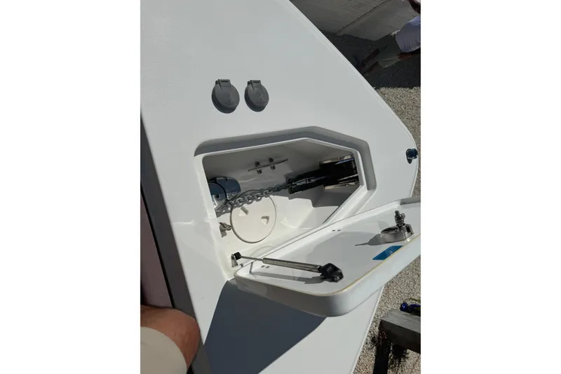 Slide: The Image of 2019 Sea Hunt Ultra 275 SE anchor compartment with open hatch and chain storage. - 32