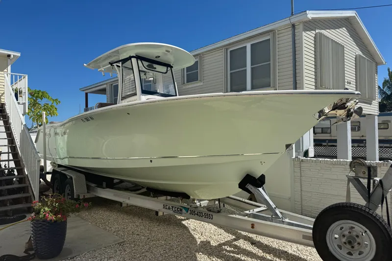 Slide: The Image of 2019 Sea Hunt Ultra 275 SE boat on trailer, parked beside a house. - 35