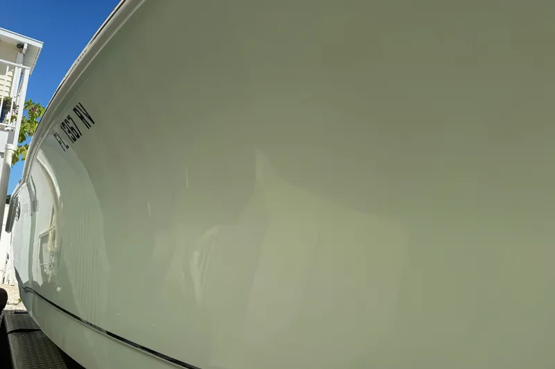 Slide: The Image of 2019 Sea Hunt Ultra 275 SE boat side view under clear blue sky. - 36