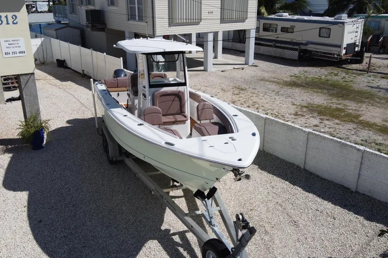 Slide: The Image of 2019 Sea Hunt Ultra 275 SE boat on trailer in residential area. - 6
