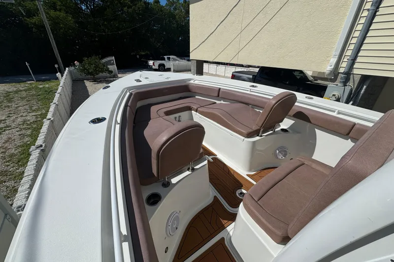 Slide: The Image of 2019 Sea Hunt Ultra 275 SE boat interior with cushioned seating and wood accents. - 9