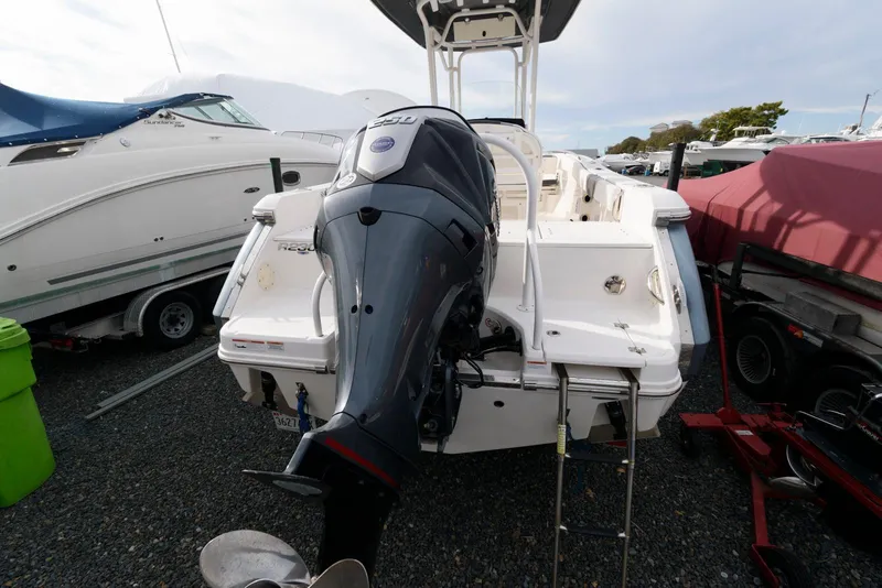 Slide: The Image of 2022 Robalo R230 Center Console boat with powerful outboard motor, docked in marina. - 23
