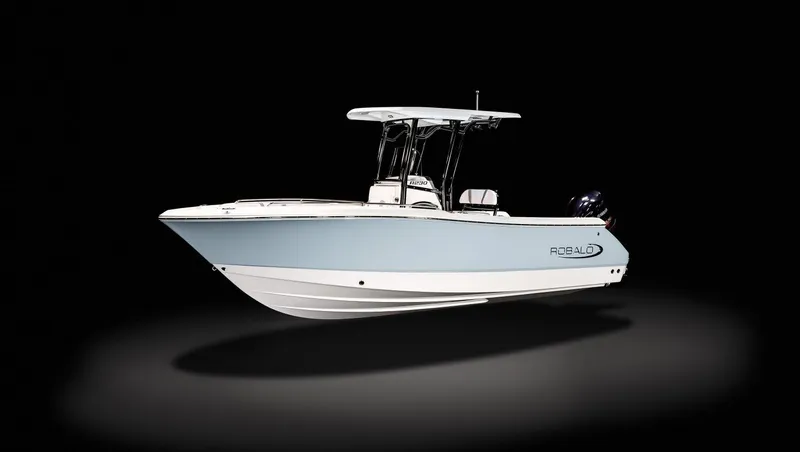 Slide: The Image of 2022 Robalo R230 Center Console boat on a trailer, parked outdoors. - 3