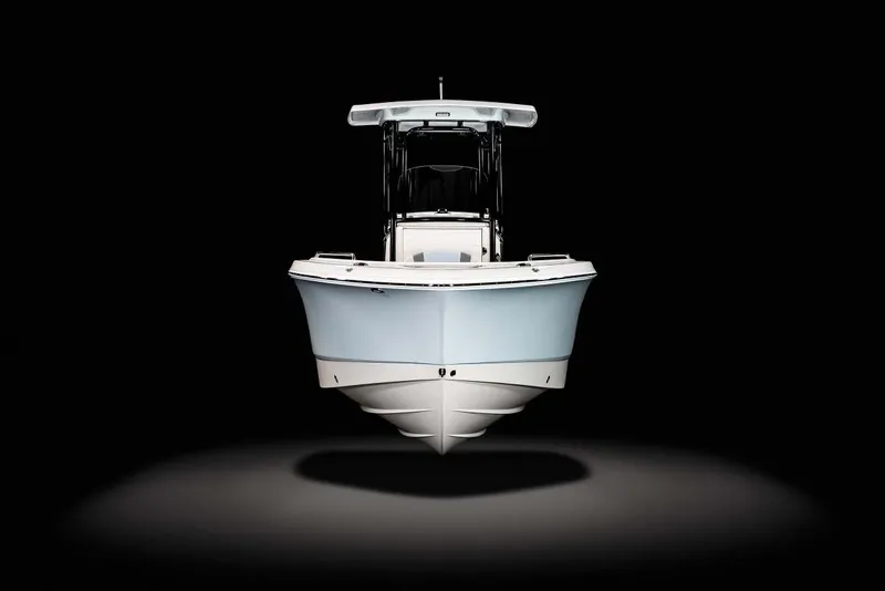 Slide: The Image of 2022 Robalo R230 Center Console boat docked on a serene lake. - 6