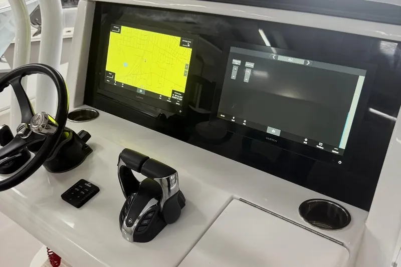 Slide: The Image of 2023 Jupiter 32 boat dashboard with dual Garmin displays and steering wheel. - 12