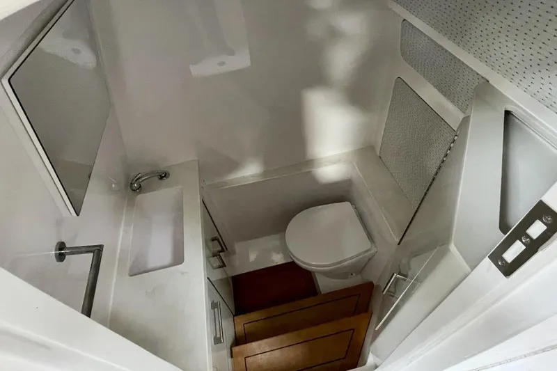 Slide: The Image of Compact bathroom in 2023 Jupiter 32 boat with sink, toilet, and mirror. - 14