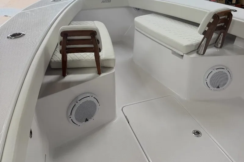 Slide: The Image of 2023 Jupiter 32 boat interior with cushioned seating and built-in speakers. - 15