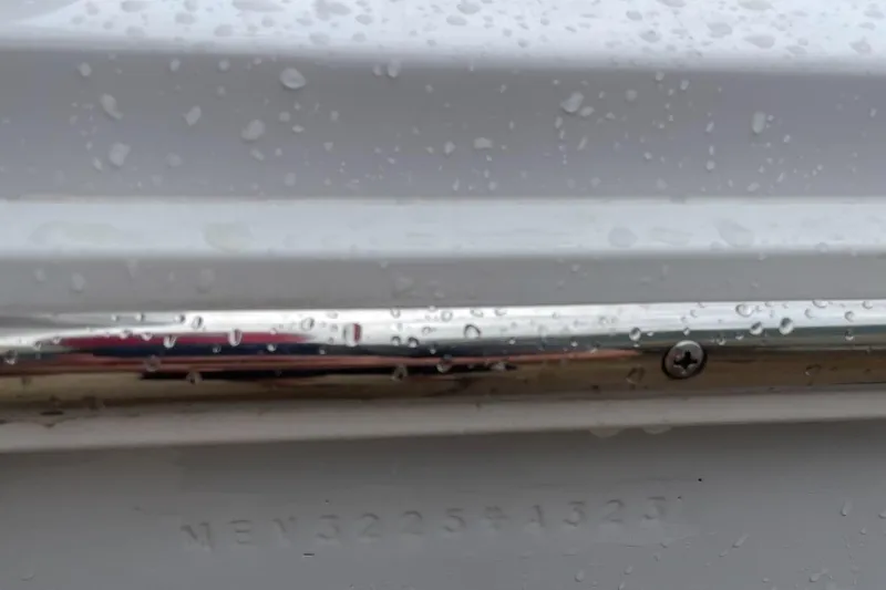 Slide: The Image of Close-up of a 2023 Jupiter 32 boat hull with water droplets. - 26