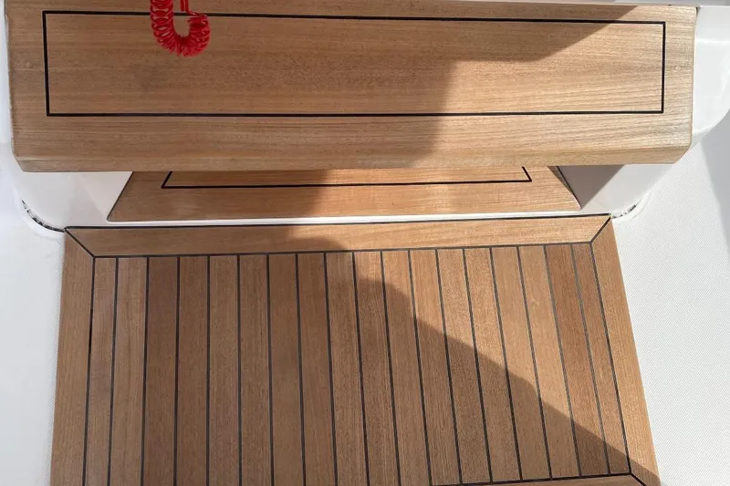 Slide: The Image of Teak deck of 2023 Jupiter 32 boat with red safety cord. - 8