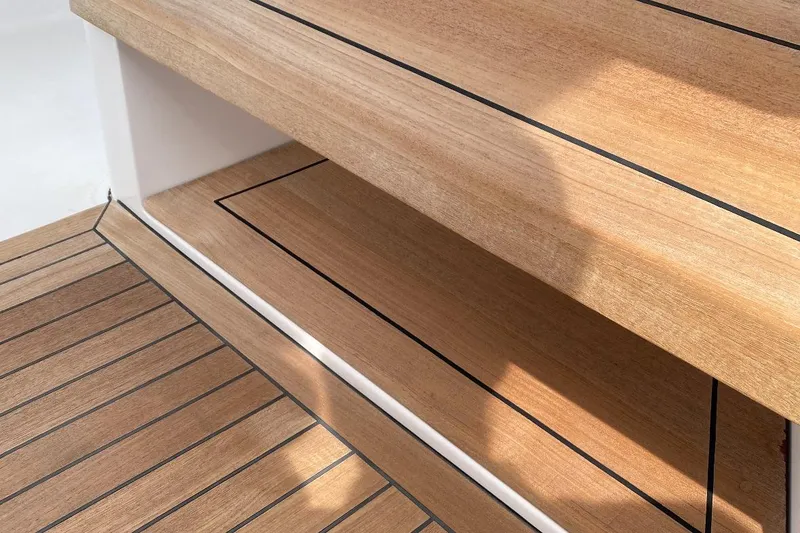 Slide: The Image of Teak wood deck of 2023 Jupiter 32 boat, featuring sleek, modern design. - 9