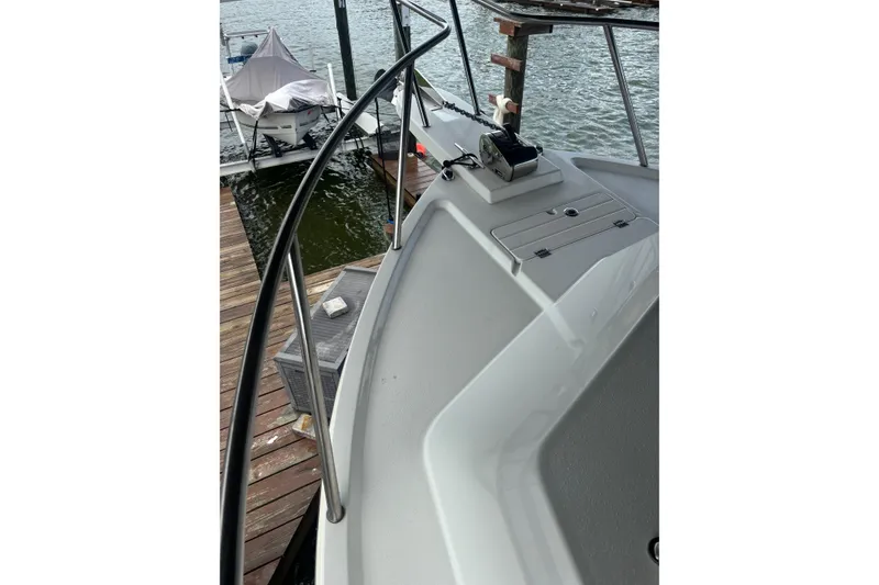 Slide: The Image of 2024 Parker 2820 XLD Sport Cabin boat docked by the water. - 17