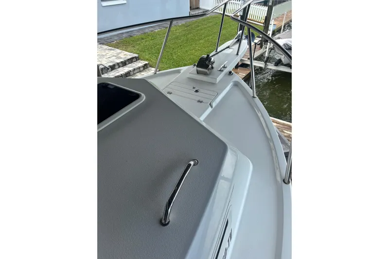 Slide: The Image of 2024 Parker 2820 XLD Sport Cabin boat deck with railing and winch. - 18