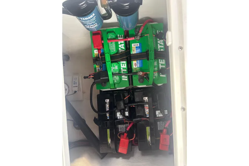 Slide: The Image of Battery compartment of 2024 Parker 2820 XLD Sport Cabin with multiple batteries and wiring. - 24