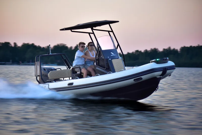 Slide: The Image of 2025 Highfield Sport 560 boat cruising on a lake at sunset. - 15