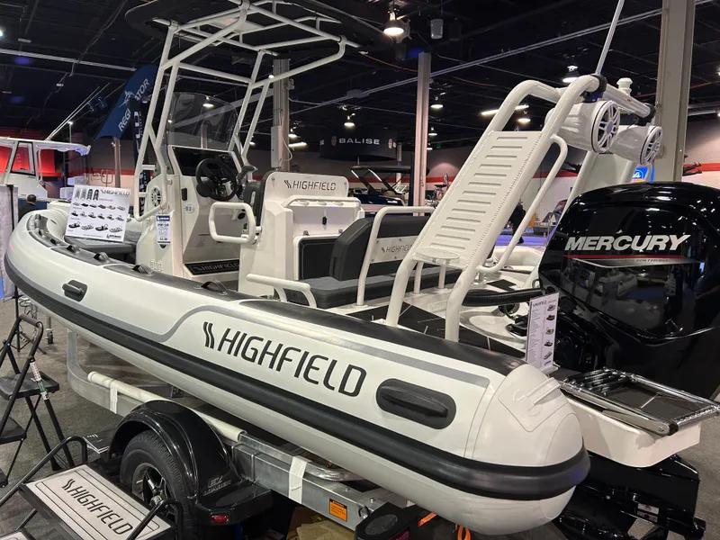 Slide: The Image of 2025 Highfield Sport 560 boat with Mercury engine on display indoors. - 19