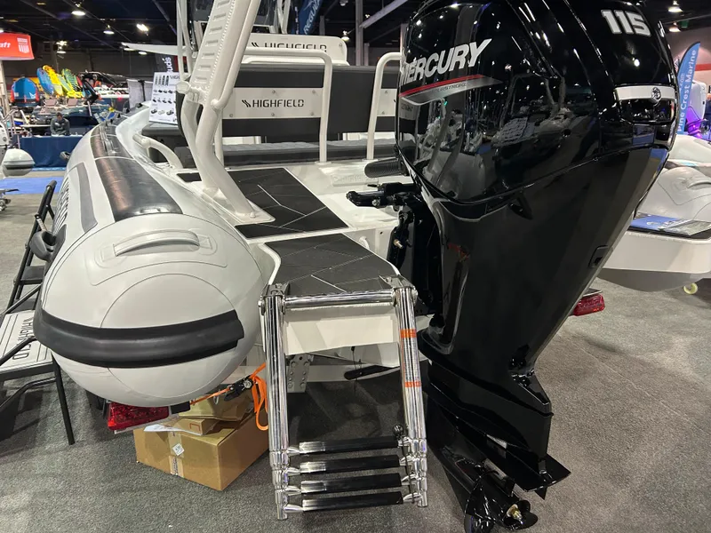 Slide: The Image of Highfield Sport 560 boat, 2025 model, with Mercury 115 engine at a boat show. - 4