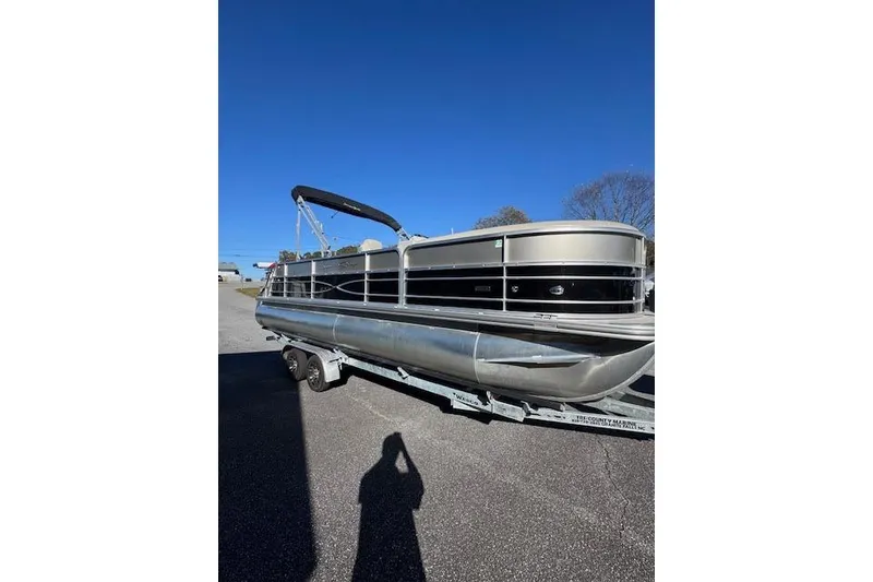The Image of 2020 South Bay 200 pontoon boat on trailer under clear blue sky. - 1