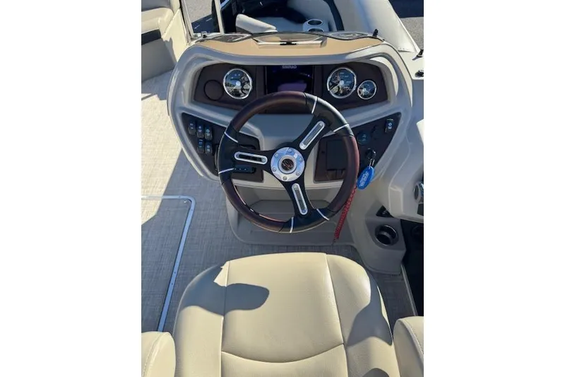 Slide: The Image of Steering console of a 2020 South Bay 200 boat with gauges and controls. - 12