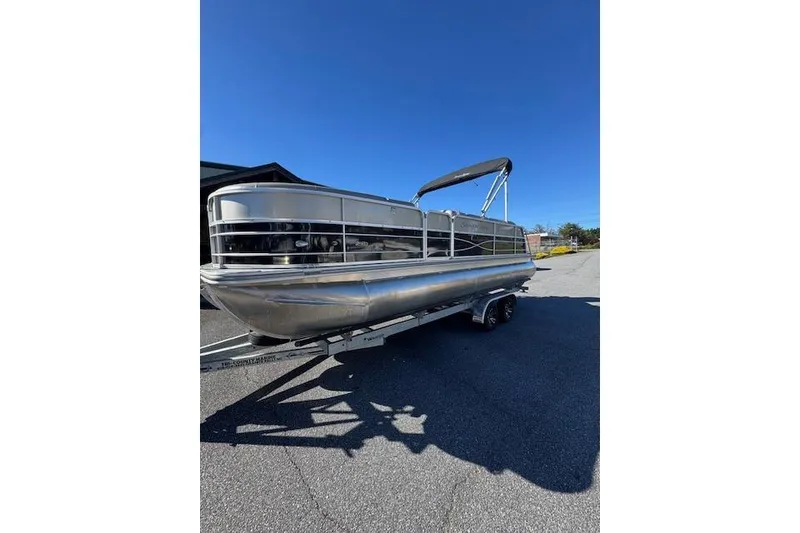 Slide: The Image of 2020 South Bay 200 pontoon boat on trailer under clear blue sky. - 3