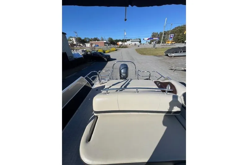 Slide: The Image of 2020 South Bay 200 pontoon boat with beige seating, parked outdoors. - 9