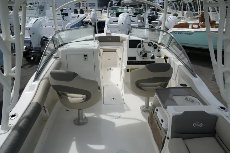 Slide: The Image of 2026 Key West 239 DFS boat interior with dual seating and modern dashboard. - 13