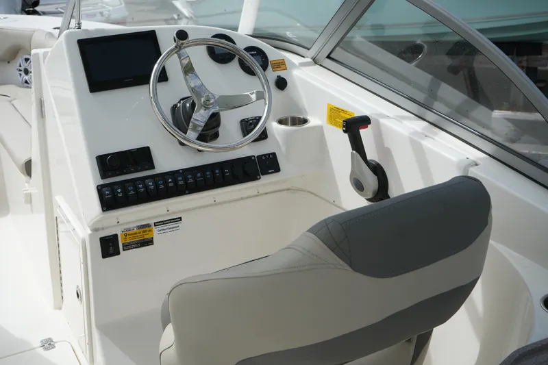 Slide: The Image of 2026 Key West 239 DFS boat cockpit with steering wheel and control panel. - 17