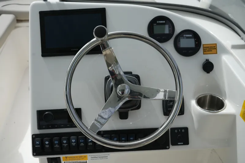 Slide: The Image of Steering console of 2026 Key West 239 DFS boat with gauges and controls. - 18