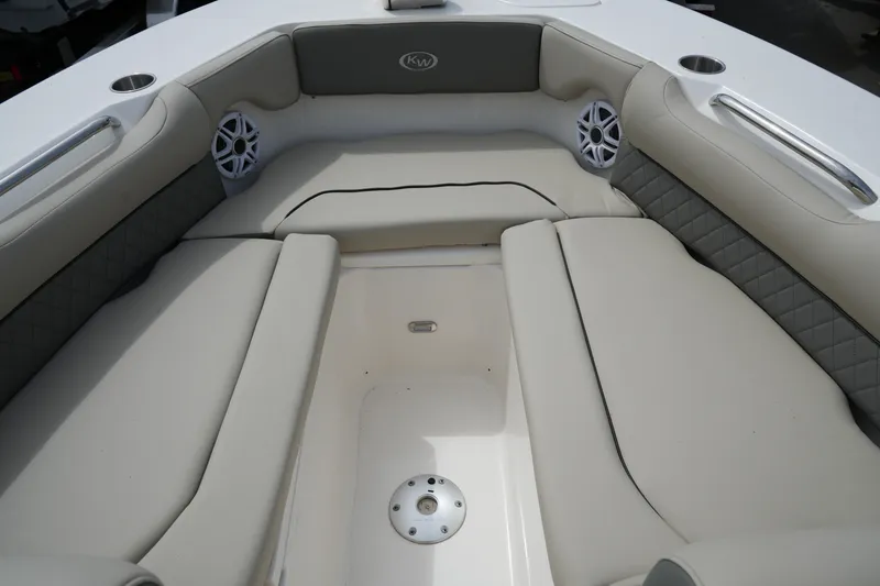 Slide: The Image of 2026 Key West 239 DFS boat interior with cushioned seating and cup holders. - 22