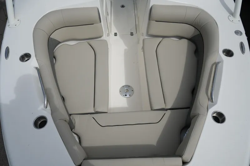 Slide: The Image of 2026 Key West 239 DFS boat interior with beige seating and cup holders. - 24