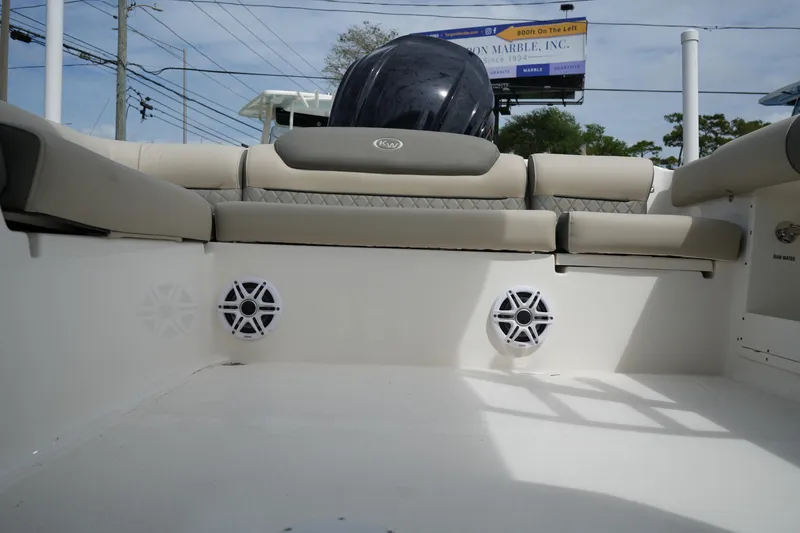 Slide: The Image of 2026 Key West 239 DFS boat interior with cushioned seating and speakers. - 32