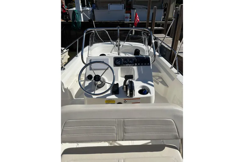 Slide: The Image of 2019 Boston Whaler 170 Montauk boat interior with steering wheel and control panel. - 12