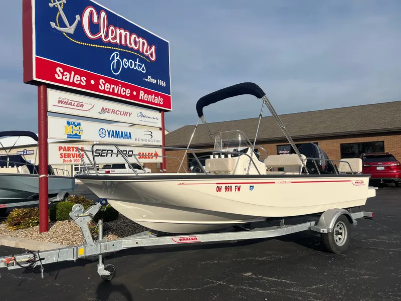 Slide: The Image of 2019 Boston Whaler 170 Montauk boat interior with steering wheel and controls. - 2