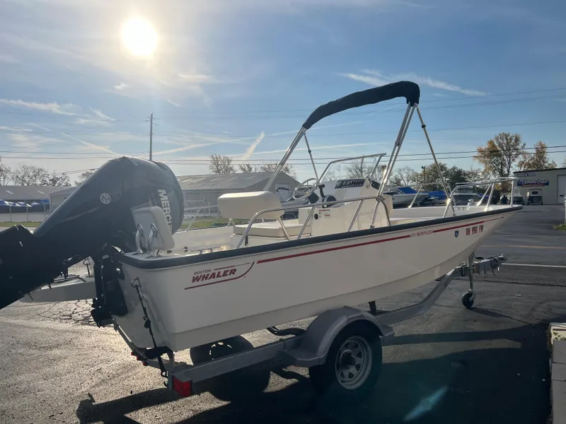 Slide: The Image of 2019 Boston Whaler 170 Montauk boat interior with seating and steering console. - 3