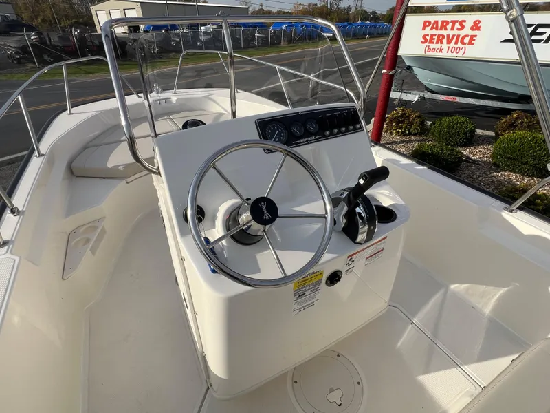Slide: The Image of 2019 Boston Whaler 170 Montauk boat interior with seating and outboard motor. - 6