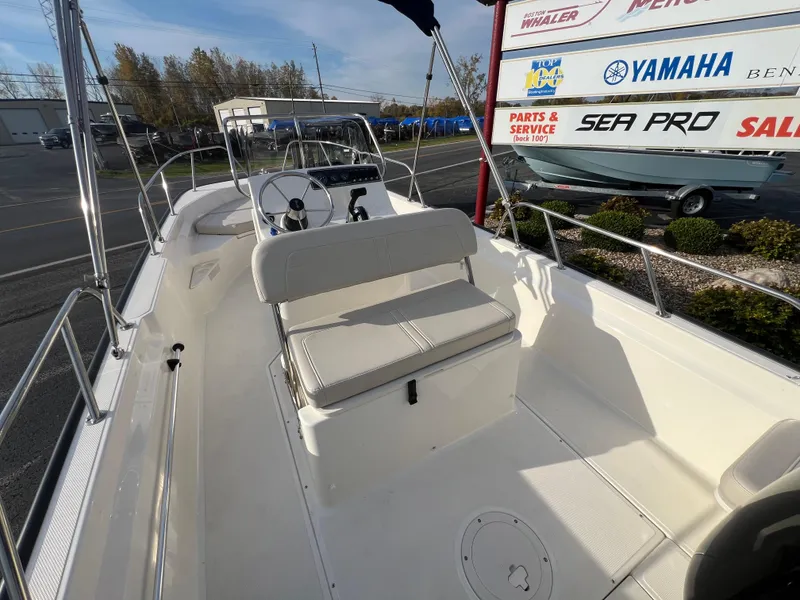 Slide: The Image of 2019 Boston Whaler 170 Montauk boat interior with seating and motor. - 8
