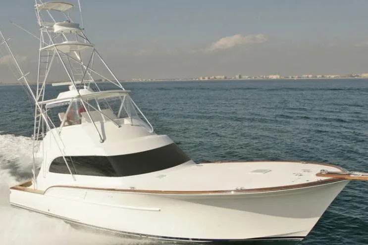 The Image of 2026 Buddy Davis 58 Sportfisherman cruising on open water under clear skies. - 0