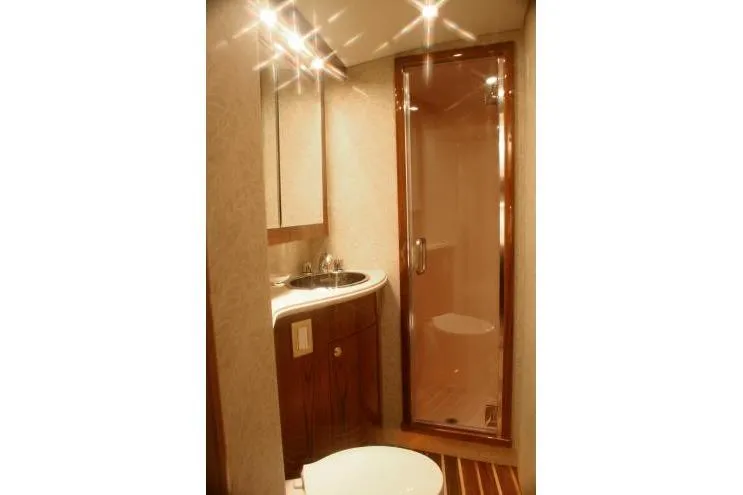 Slide: The Image of Luxurious bathroom in 2026 Buddy Davis 58 Sportfisherman yacht, featuring elegant wood finishes. - 8