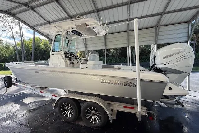 Slide: The Image of 2023 Everglades 253 Center Console boat on trailer under shelter. - 10