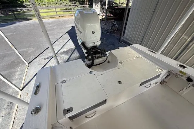 Slide: The Image of 2023 Everglades 253 Center Console boat with powerful outboard motor in a driveway. - 16