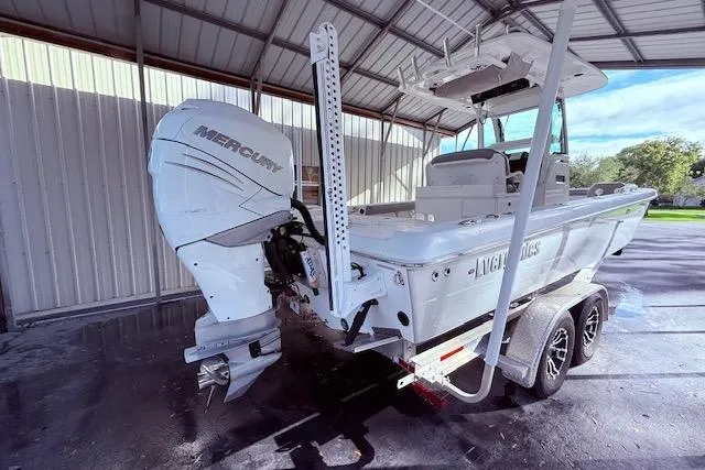 Slide: The Image of 2023 Everglades 253 Center Console boat with Mercury engine in covered storage. - 4