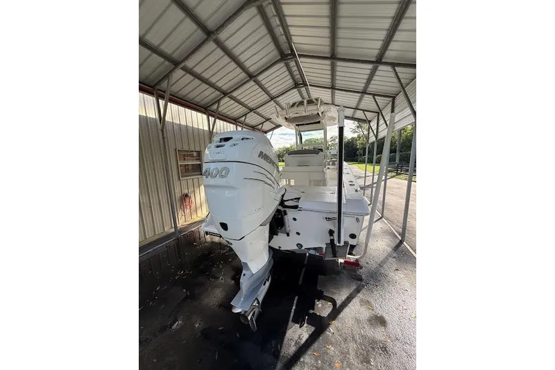 Slide: The Image of 2023 Everglades 253 Center Console boat with Mercury 400 engine under a metal canopy. - 5