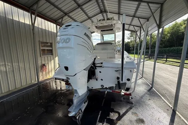 Slide: The Image of 2023 Everglades 253 Center Console boat with powerful outboard motor under a metal canopy. - 6