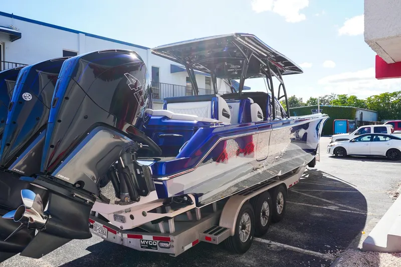 Slide: The Image of 2020 Nor-Tech 390 Center Console boat on trailer, featuring powerful outboard engines. - 3