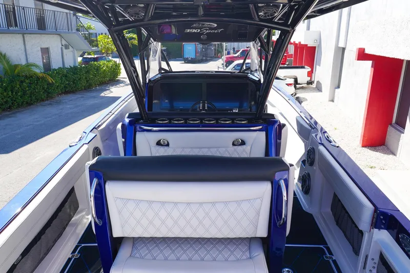 Slide: The Image of 2020 Nor-Tech 390 Center Console boat interior with luxurious seating and modern dashboard. - 7