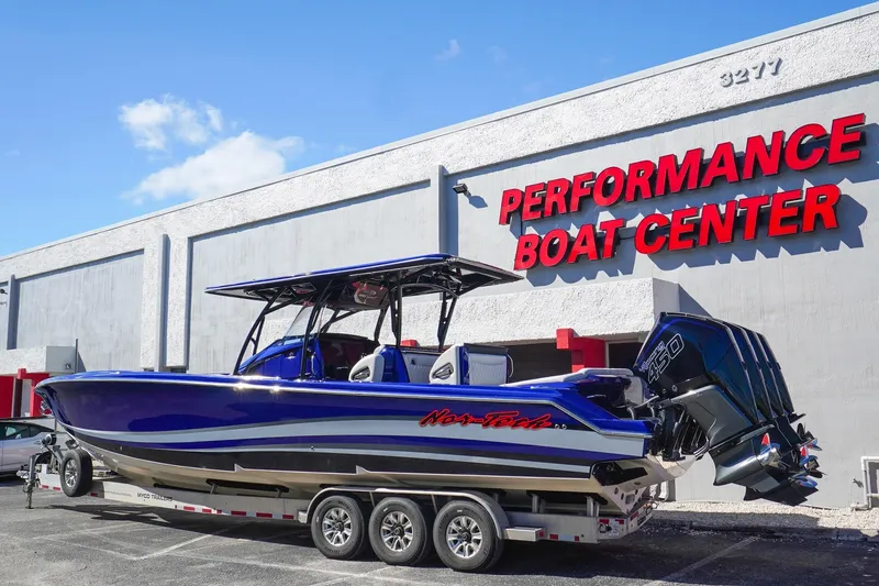 Slide: The Image of 2020 Nor-Tech 390 Center Console boat at Performance Boat Center, featuring triple engines. - 8