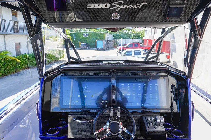 Slide: The Image of 2020 Nor-Tech 390 Center Console dashboard with advanced touchscreen controls and steering wheel. - 9