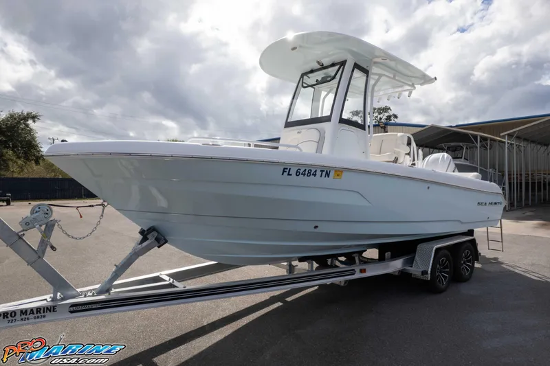 Slide: The Image of 2023 Sea Hunt Escape 23 boat on trailer under cloudy sky. - 1